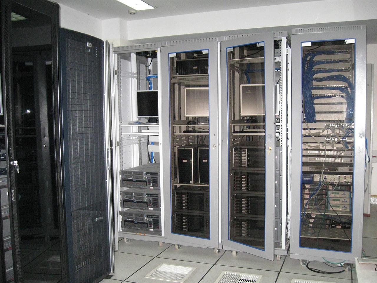 Racks of network equipment in a server room, the kind of edge infrastructure Cisco ASA and FTD appliances sit in front of