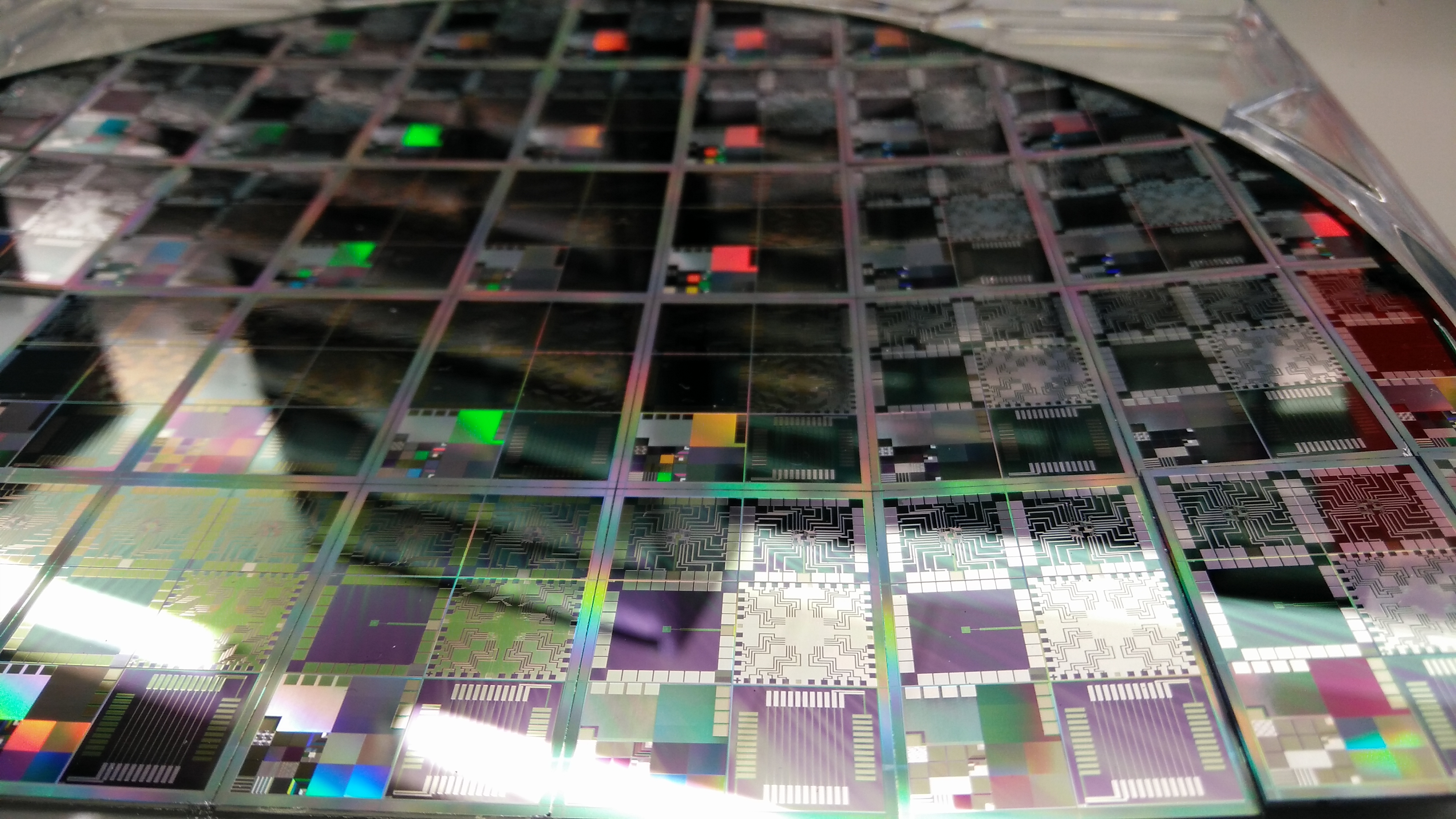 A close-up of an advanced semiconductor wafer, illustrating the leading-edge manufacturing the AI industry is racing to control