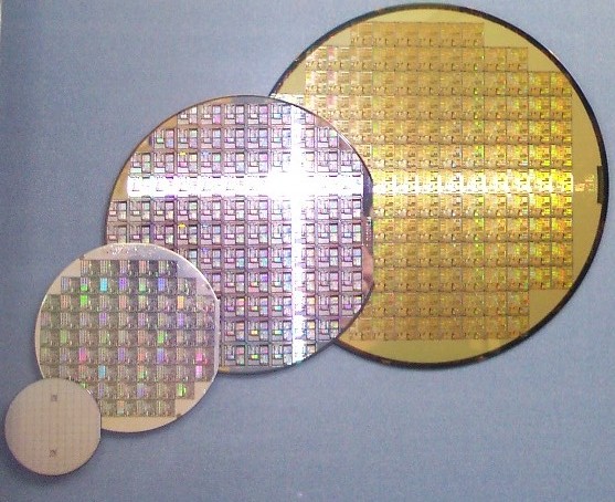 A stack of silicon wafers of varying sizes — the raw material from which accelerators like Meta's Iris are cut